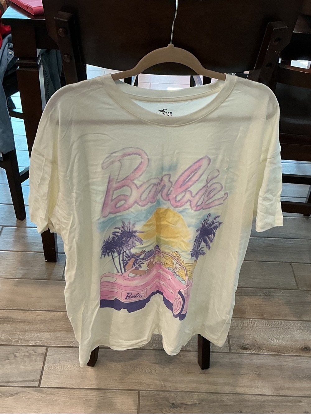 Barbie Cream Short Sleeve Tee with Pink Script and Pastel Beach Graphic